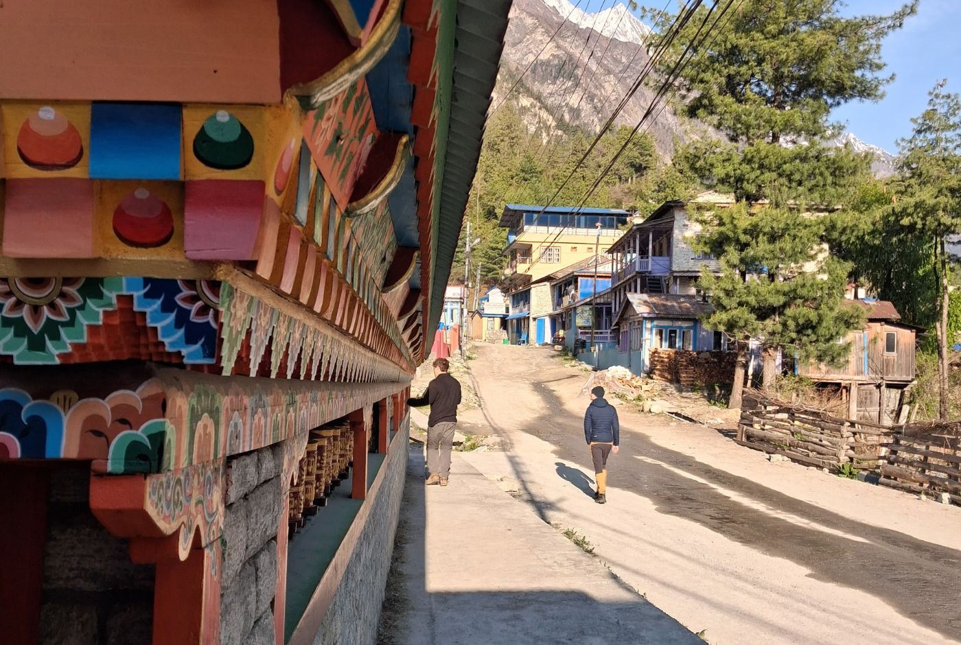 Prayer-wheel wall and village street in Chame on the Annapurna Circuit Trek