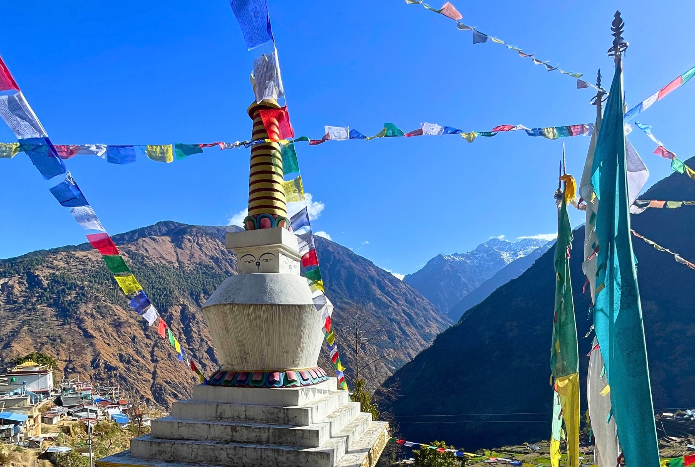 Stupa in a mountain village with prayer flags in the Langtang region, Nepal