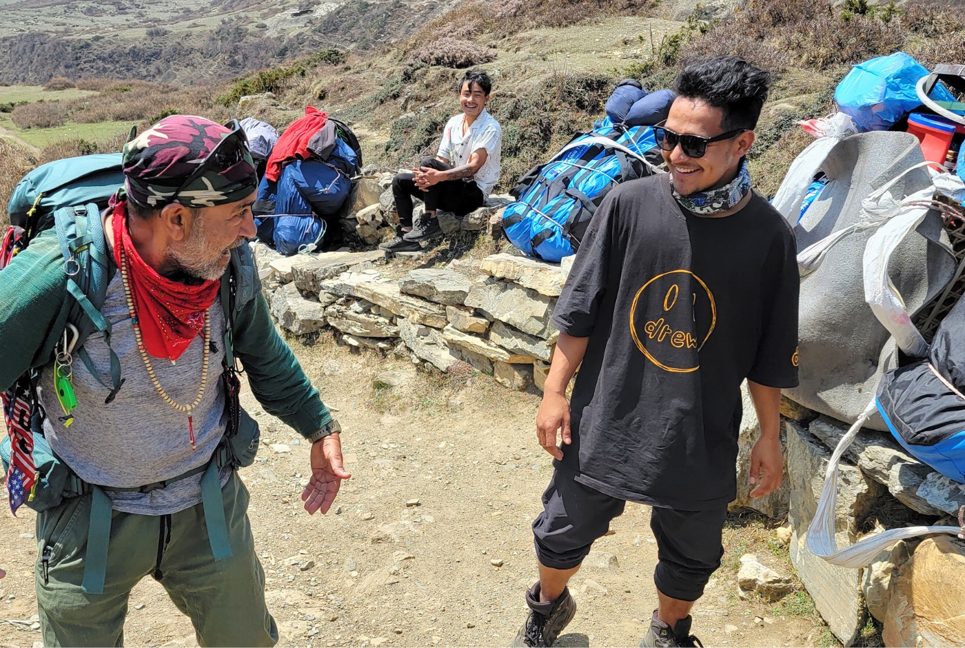 Trekking crew and porter loads on the Manaslu region trail in Nepal