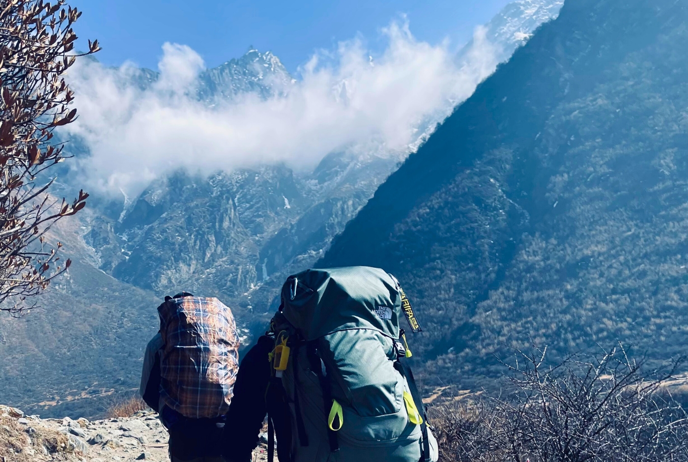 Porters carrying large trekking loads in the Langtang region of Nepal