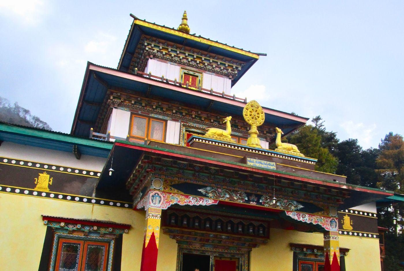 Ornate Tibetan Buddhist monastery in Tsum Valley Nepal with golden dharma wheel and colorful facade