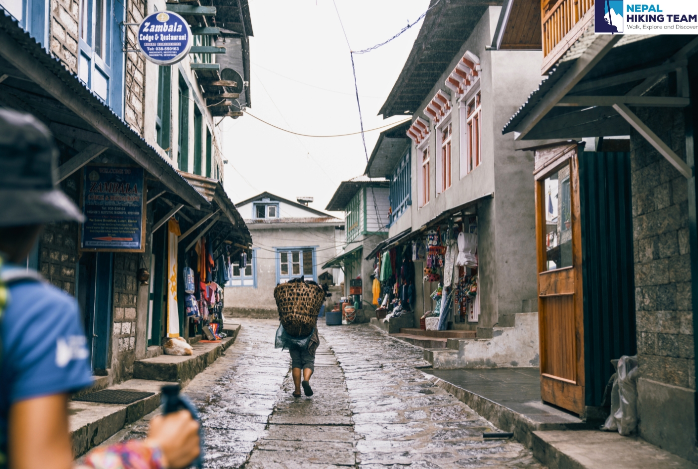 Local Porter with a load walking in the path of lukla