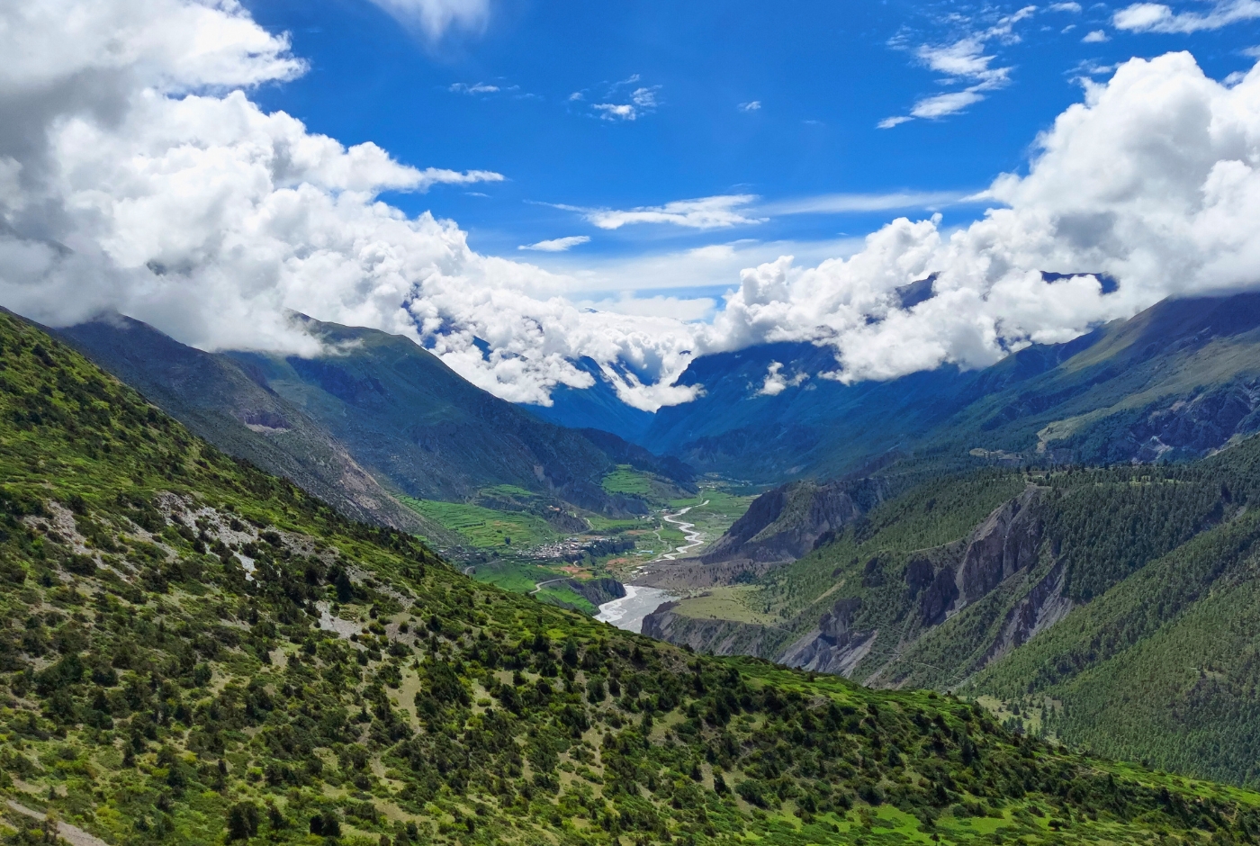 Wide view of the Manang Valley with river and surrounding mountains on the Annapurna Circuit