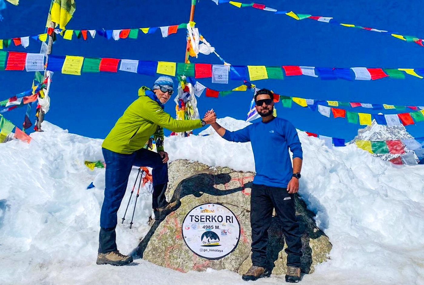 Trekkers celebrating at Tsergo Ri summit at 5,050 meters on the extended Langtang Valley Trek itinerary