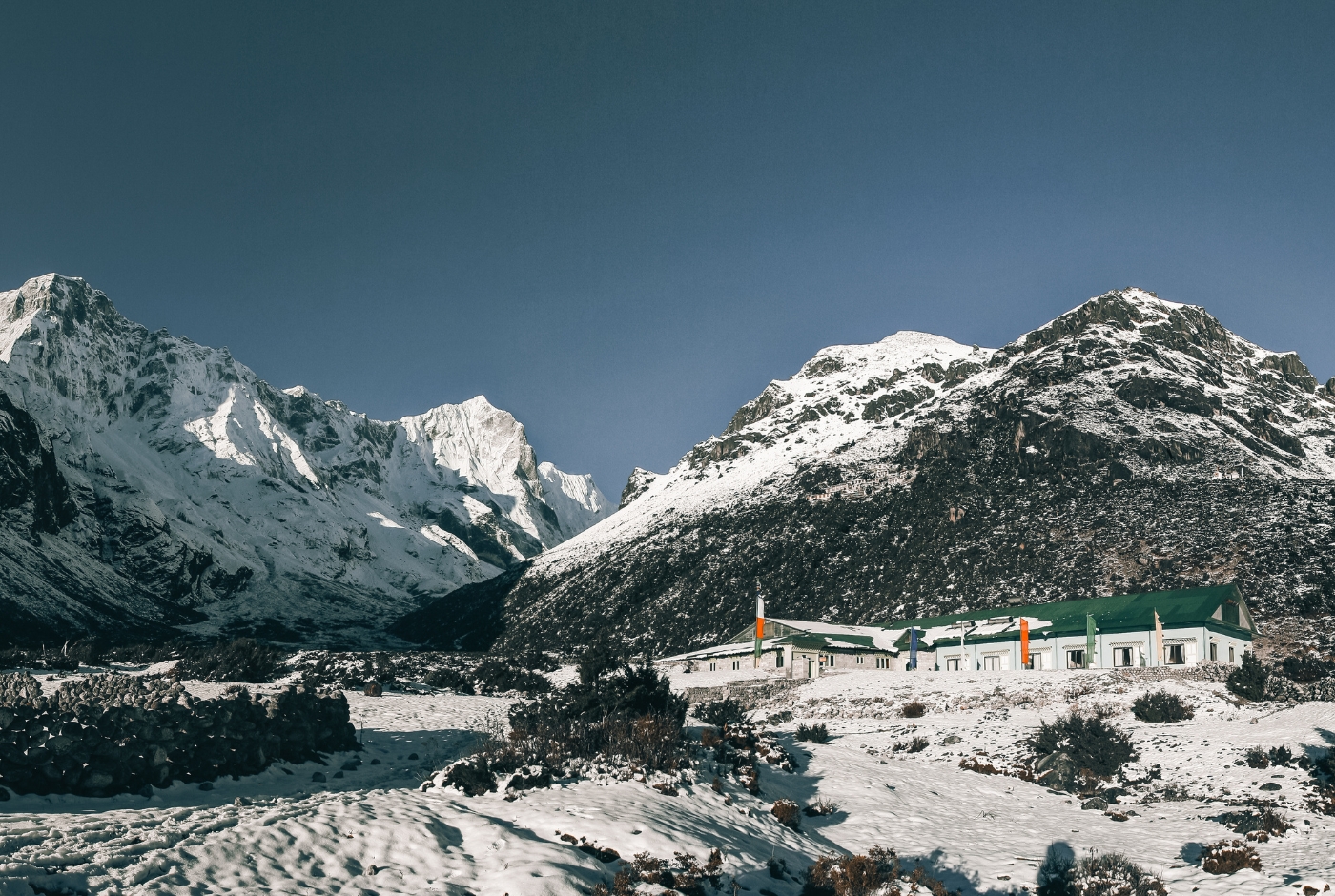 Tengboche Monastery with snow-covered grounds and Mount Everest, Lhotse, and Ama Dablam peaks in winter season
