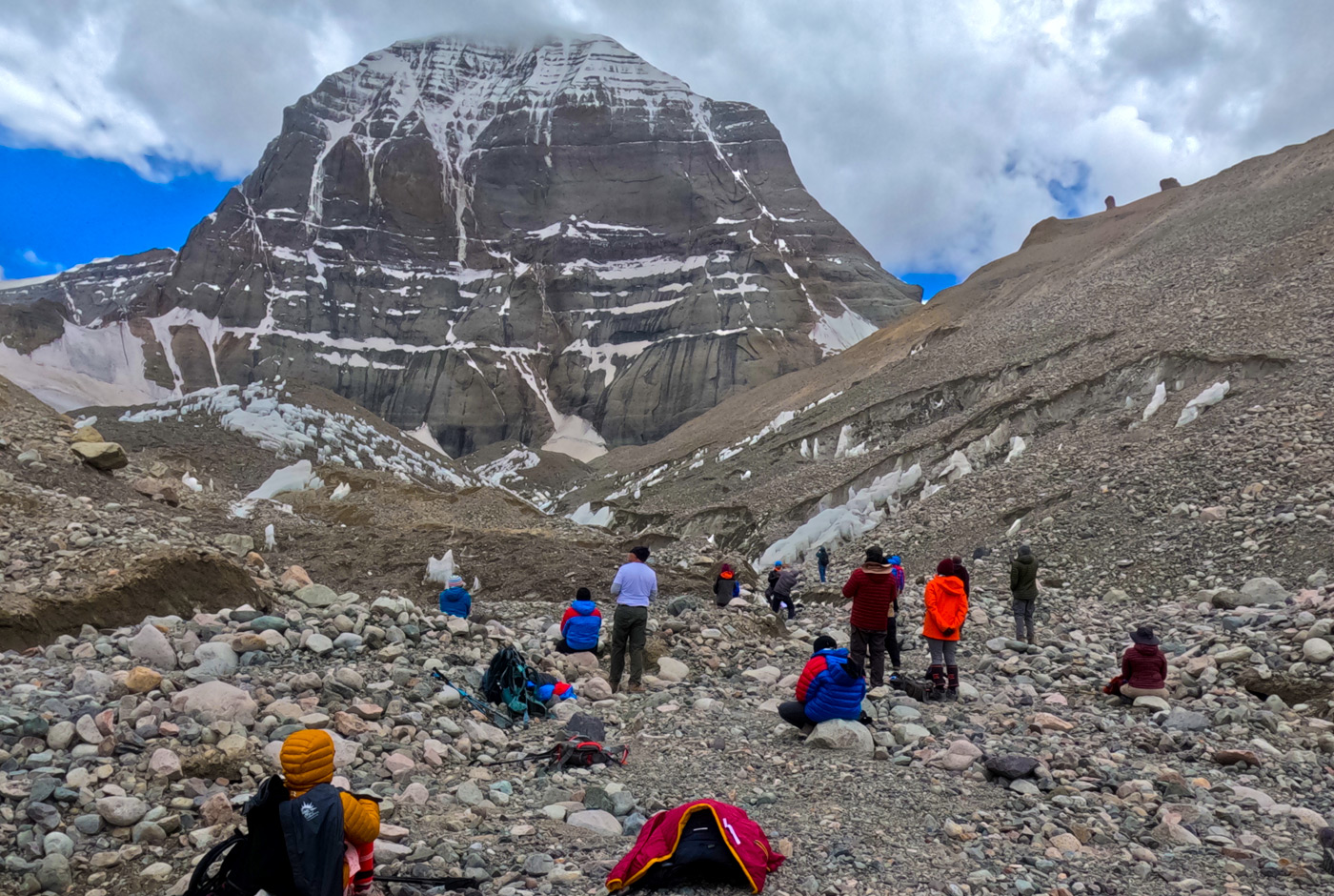 Pilgrims resting on the Mount Kailash Kora beneath the north face of Mount Kailash in western Tibet