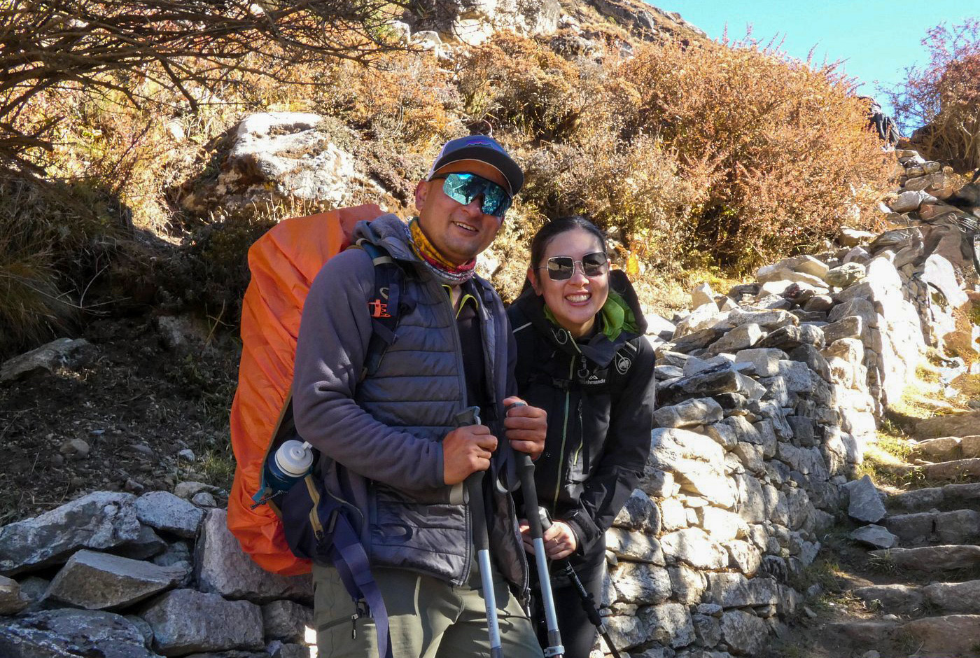 Trekkers taking photos on the Everest Base Camp trail, showing the value of booking with a local Nepali trekking agency